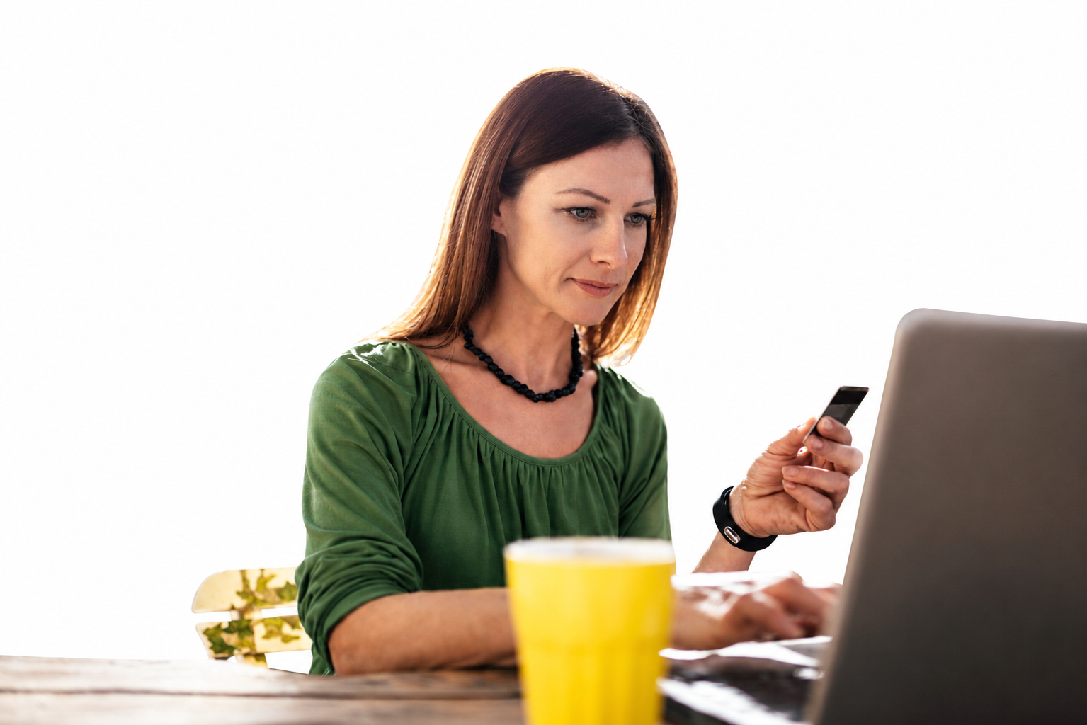 Homeowner browsing landscaping websites on a laptop